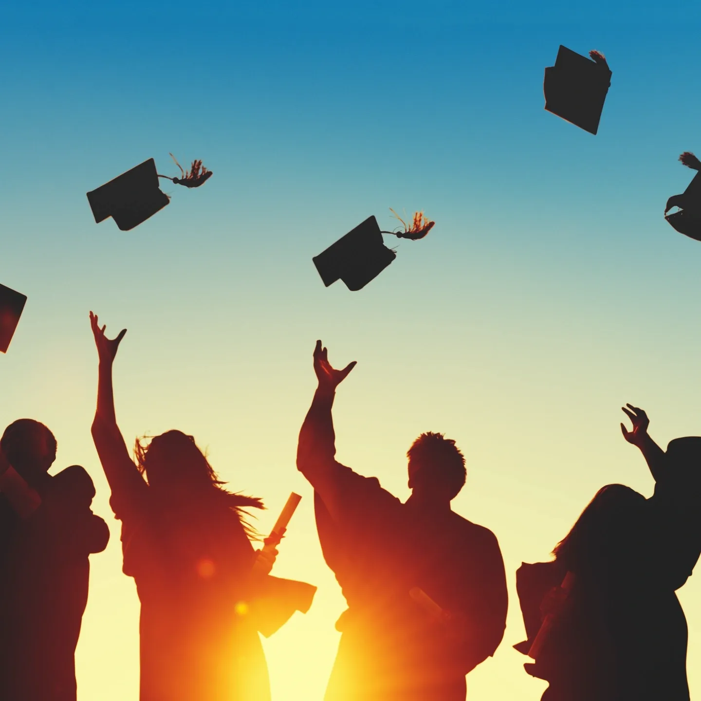 Graduates throwing their caps in the air