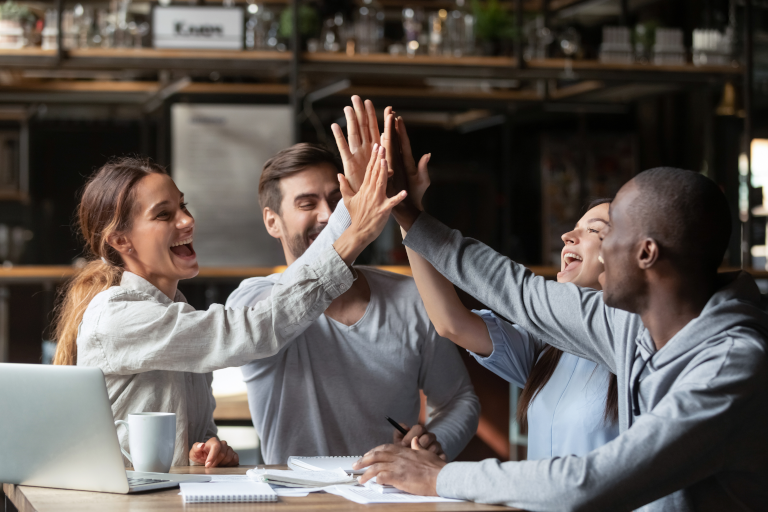 Group of people high-fiving each other